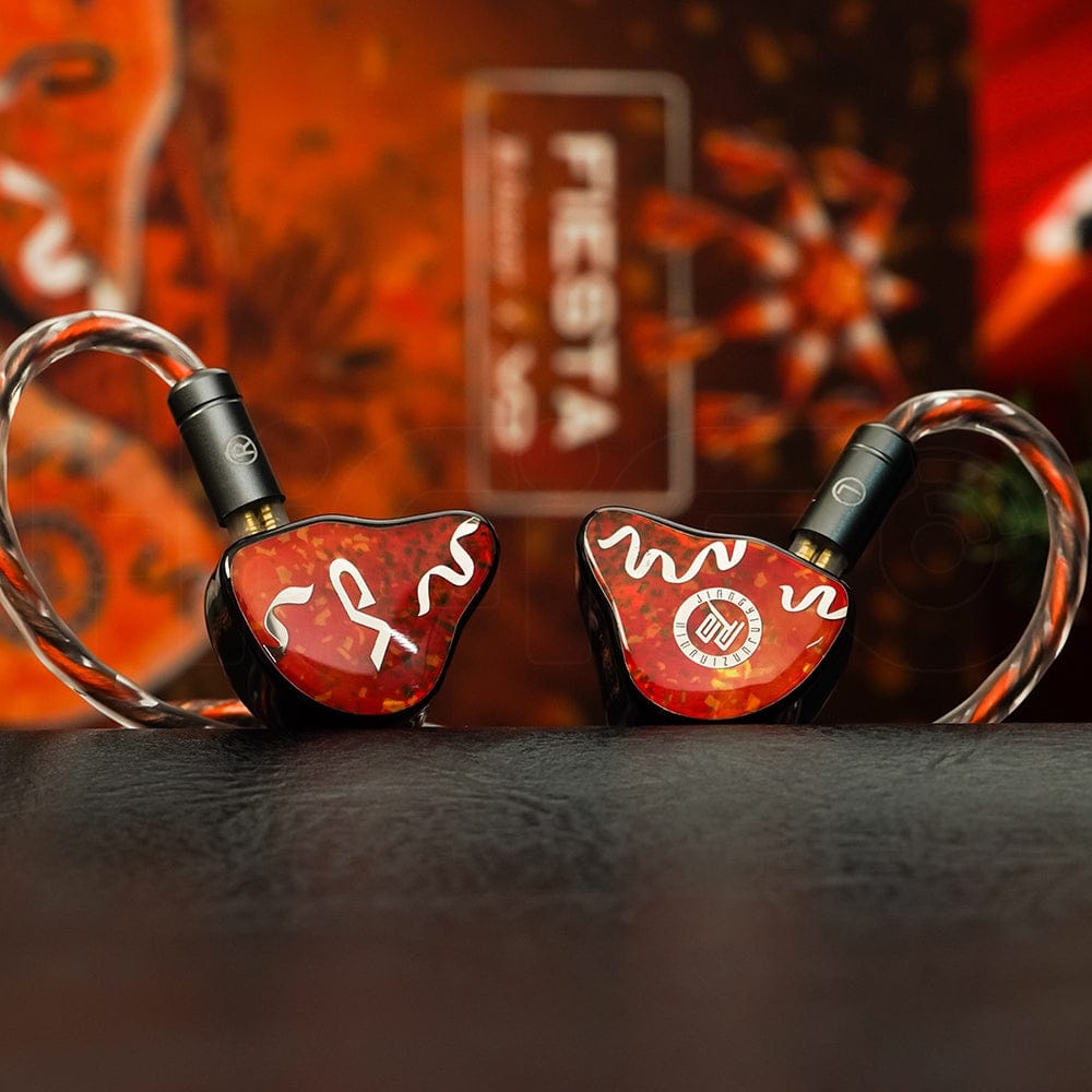 Juzear Fiesta pair — orange and chocolate piñata faceplates in front of the retail box. Photo: Juzear Audio.