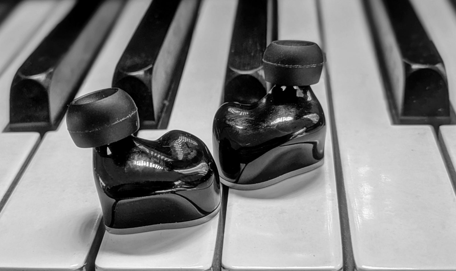 Both shells with tips fitted, nozzle side, on piano keys. Photo: Sonic Compass.