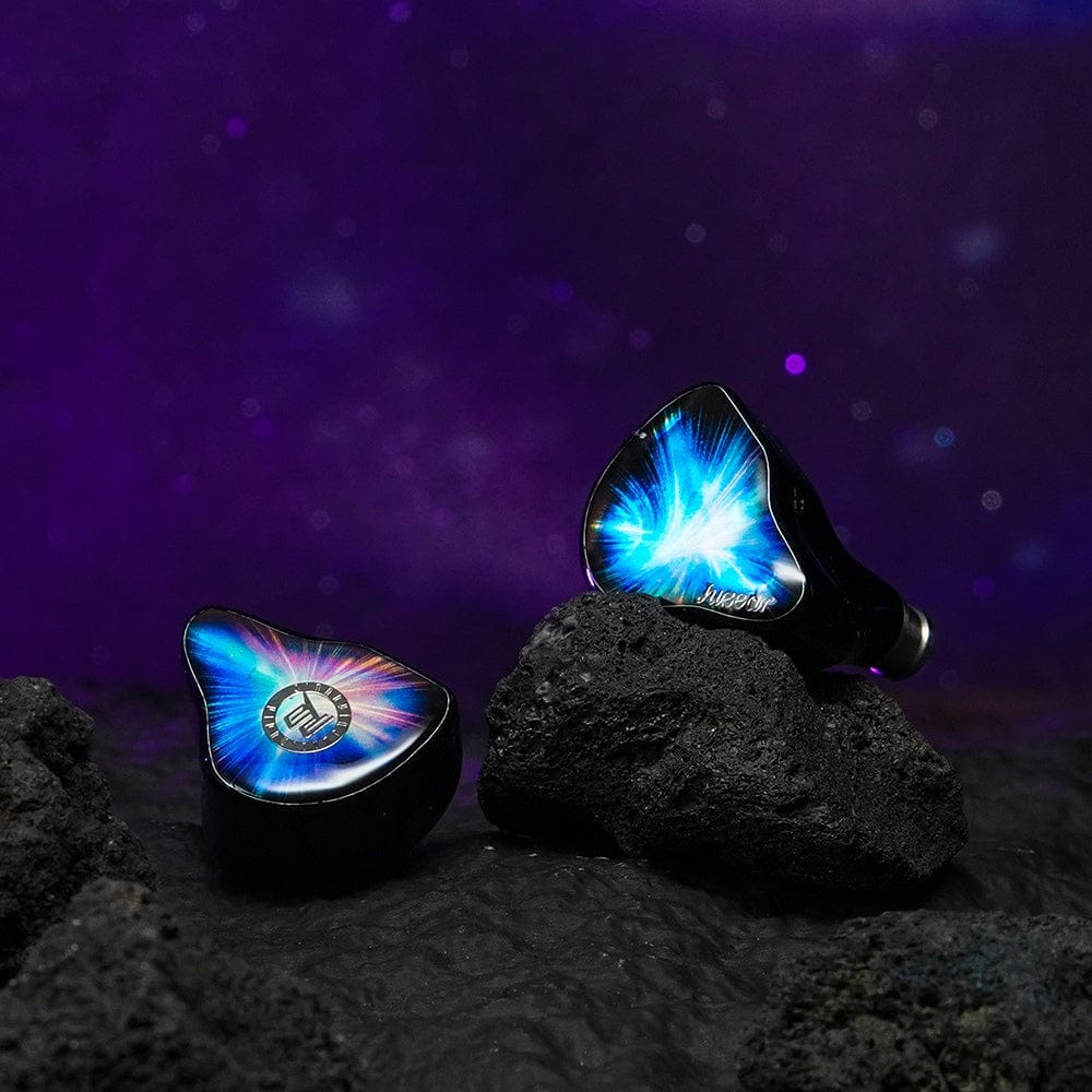 Juzear Nebula pair — nebula-blue Phantom Colour faceplates on volcanic rock. Photo: Juzear Audio.